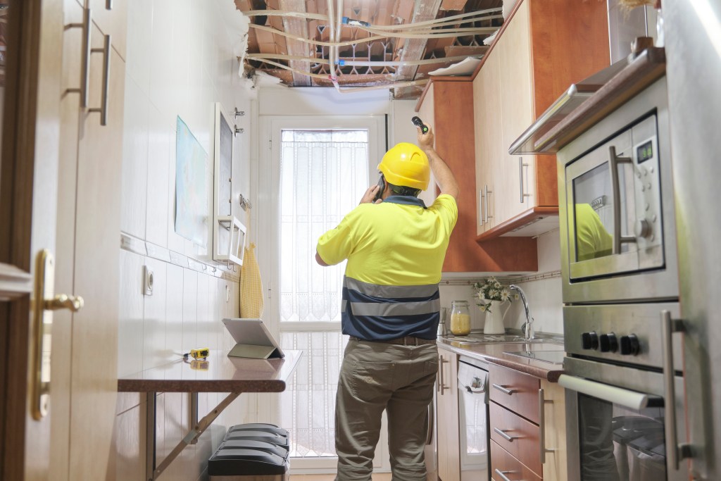 A plumber assesses damage from a broken pipe that could have been the result of a bad contractor.