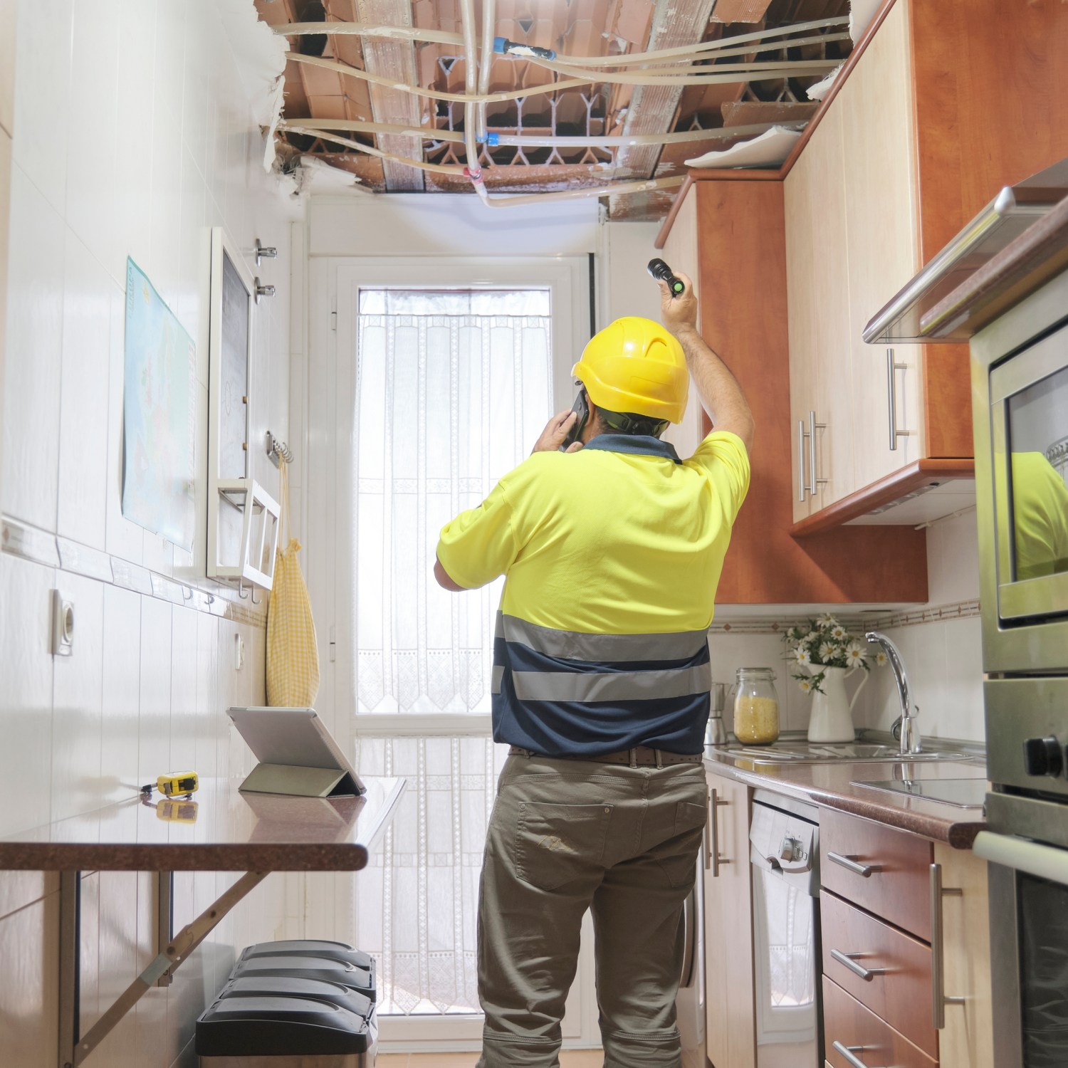 A plumber assesses damage from a broken pipe that could have been the result of a bad contractor.