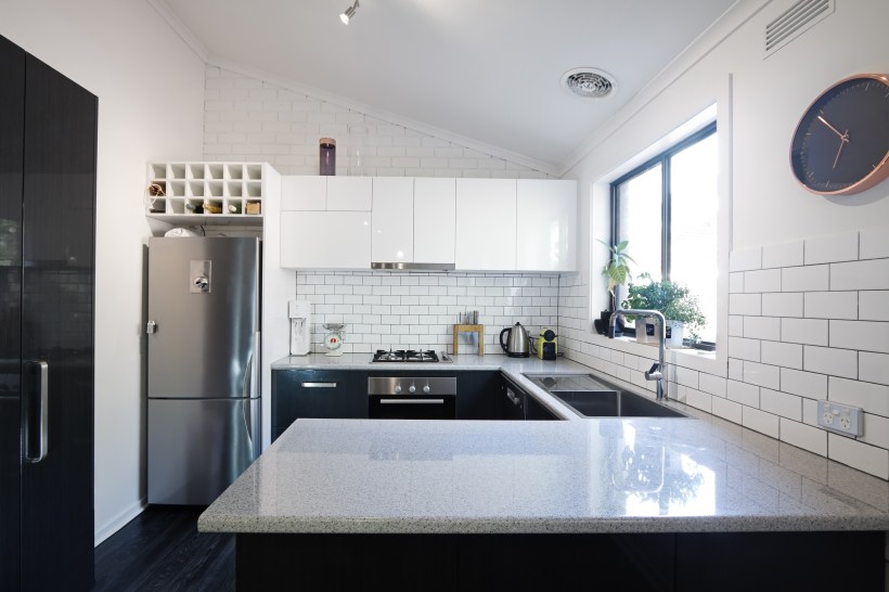New contemporary kitchen featuring a timeless black and white design with a variety of appliances.