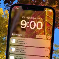 Cell phone reminder to complete home maintenance tasks on a seasonal background.
