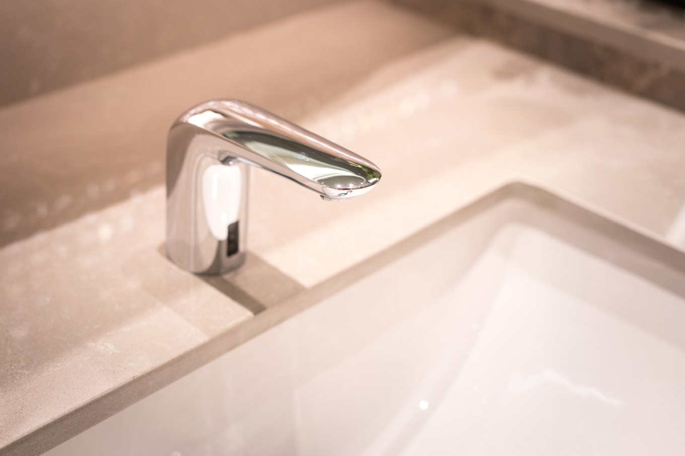 A luxury motion-activated faucet in a remodeled bathroom.