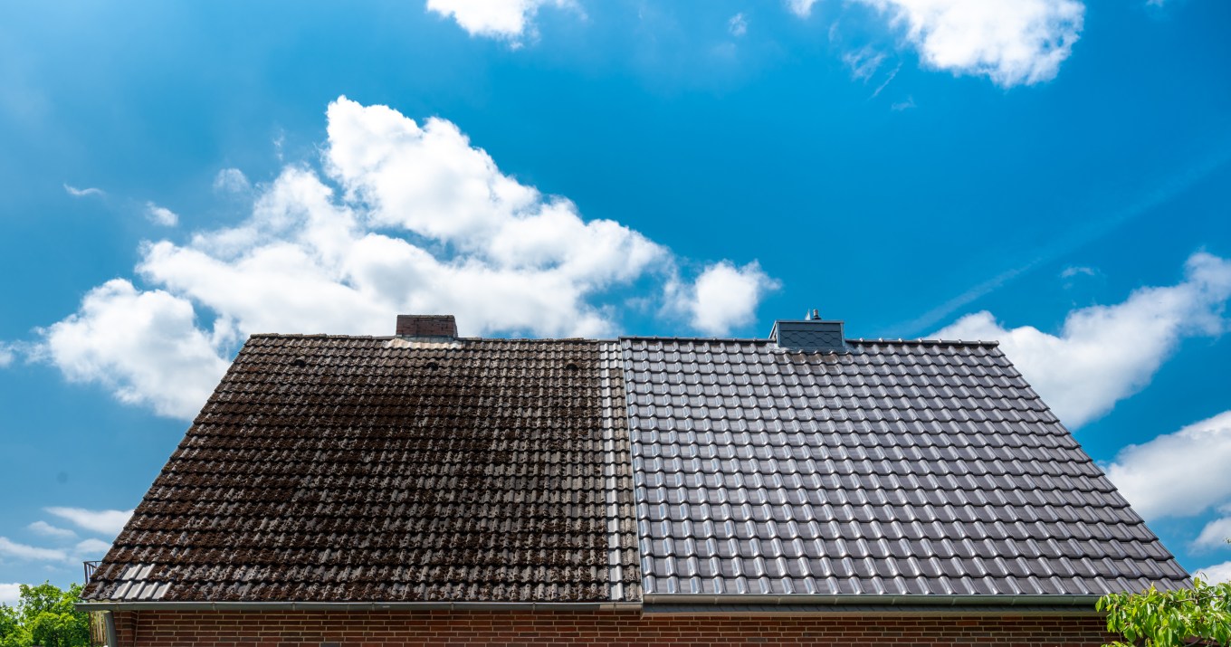A half-cleaned roof shows the contrast between a well kept, clean roof and a dirty one.