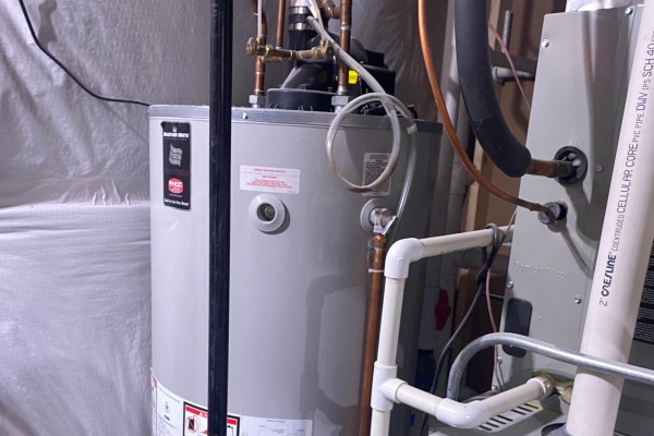 Photo of a gray storage-tank water heater, an example of a replacement for an old one.