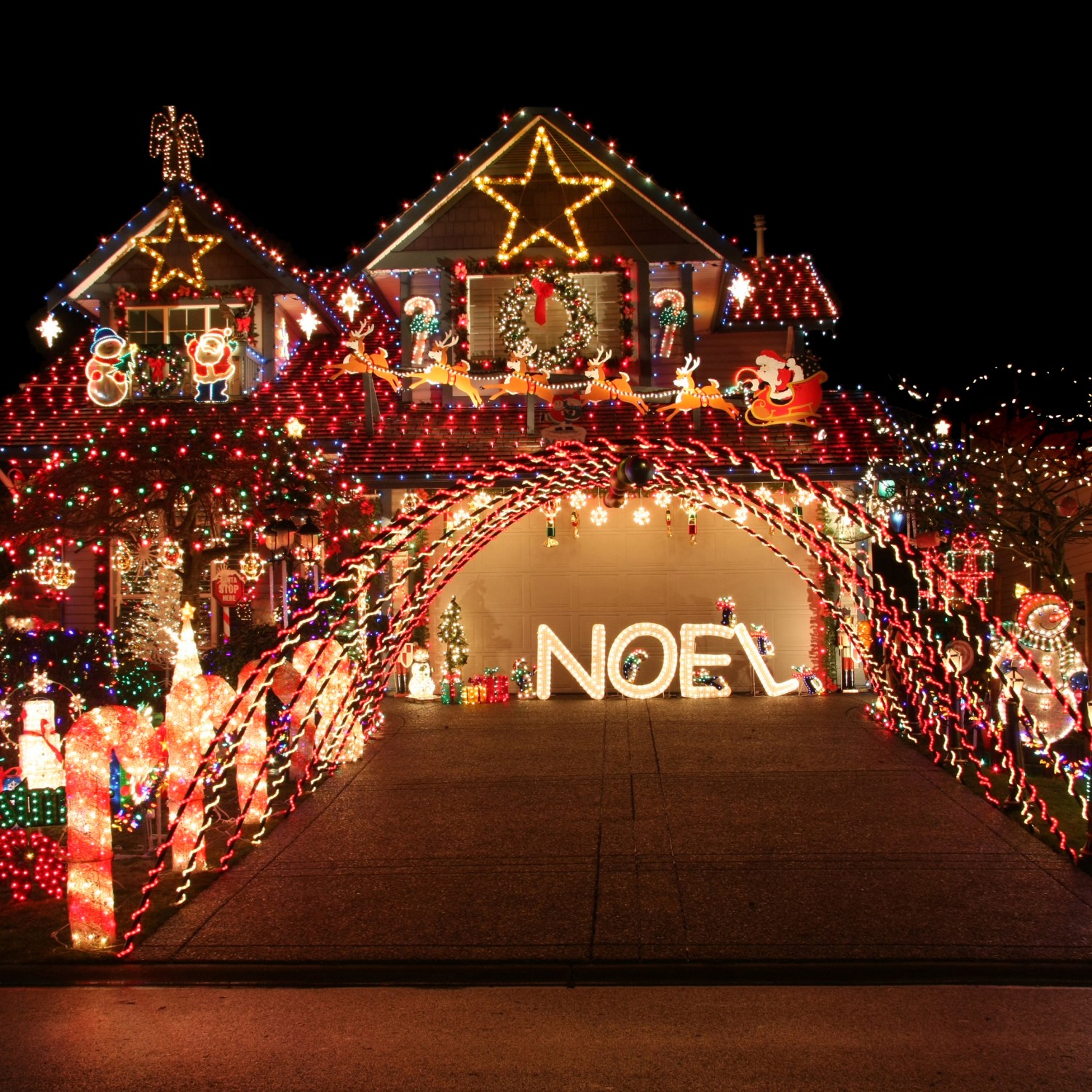 House and yard with a vibrant, beautiful and extravagant Christmas light display.