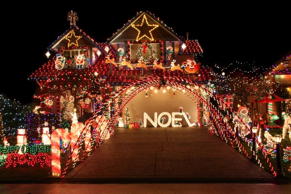 House and yard with a vibrant, beautiful and extravagant Christmas light display.