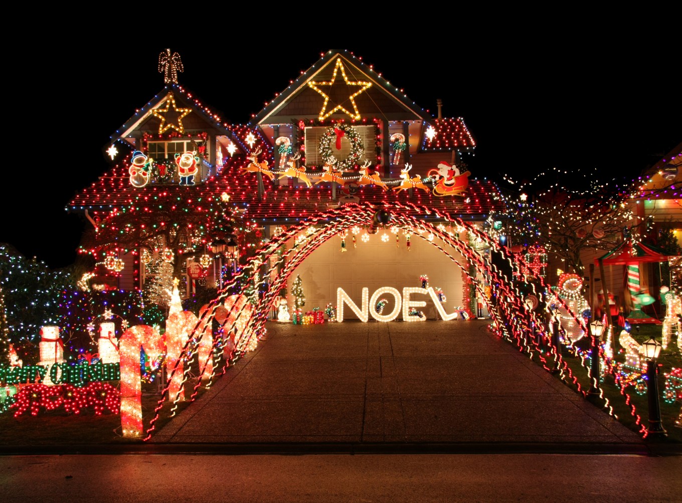 House and yard with a vibrant, beautiful and extravagant Christmas light display.