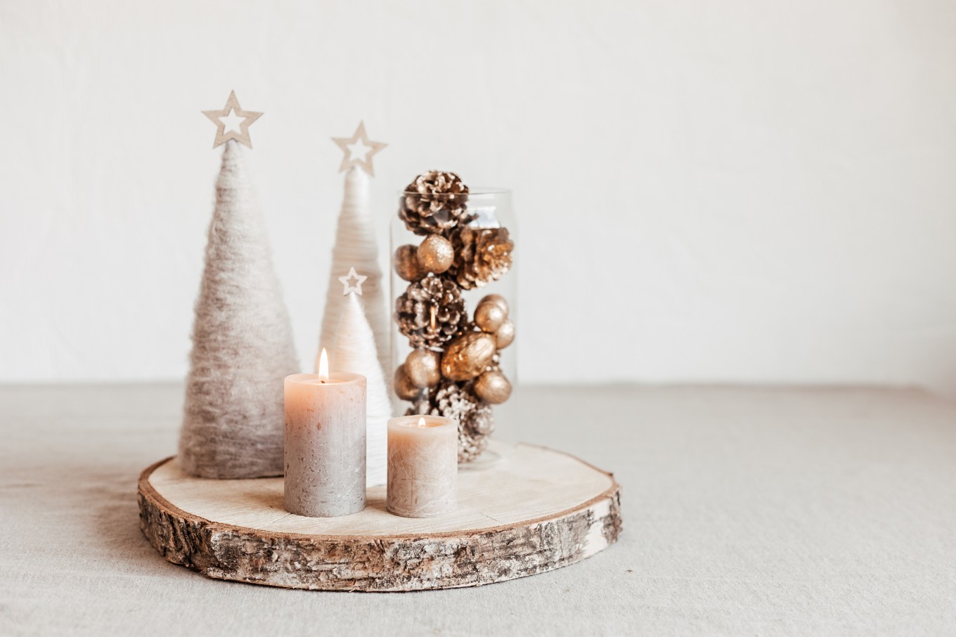 Christmas table decoration with candles and handmade minimalist Christmas trees.