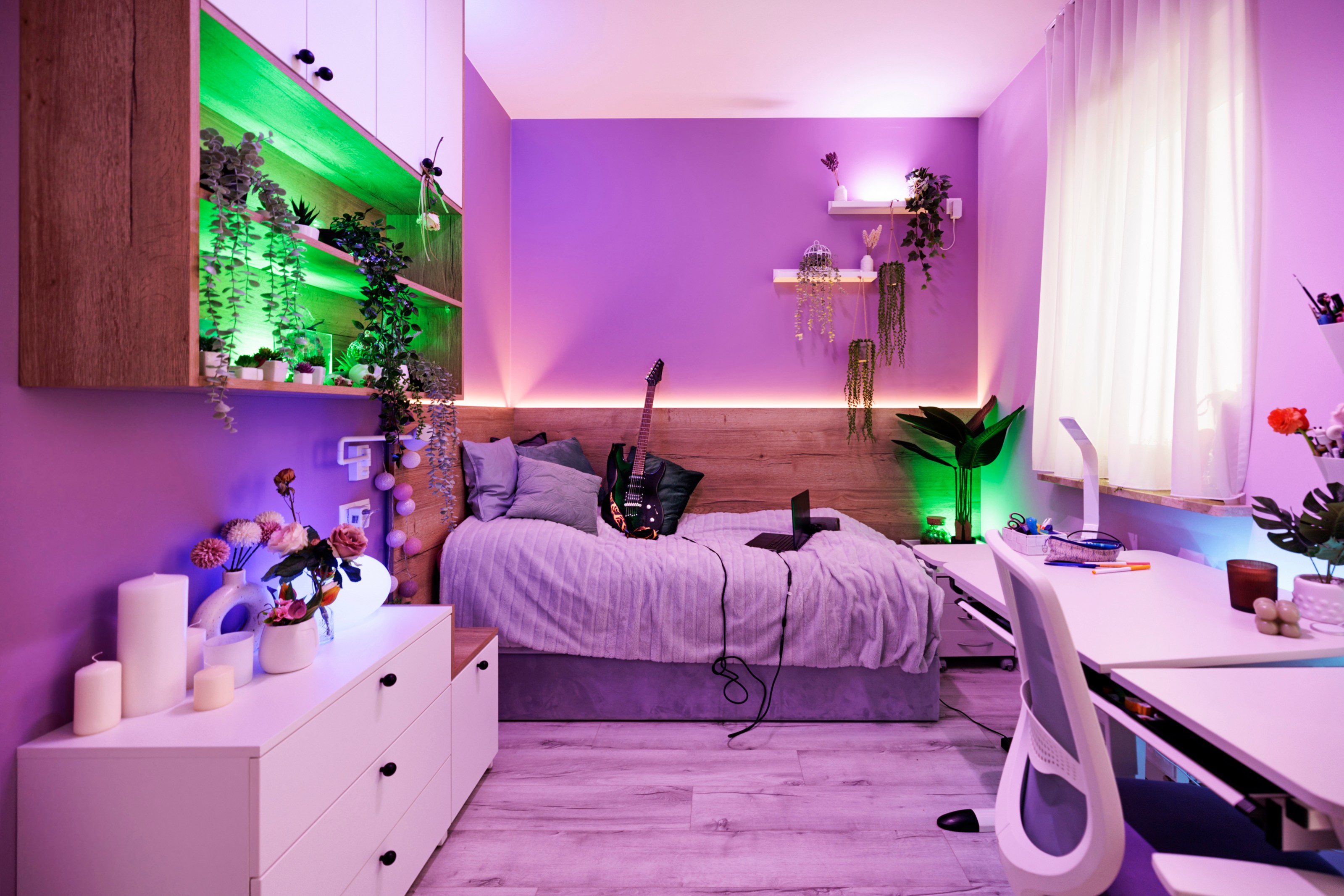 Very personalized gen-z bedroom with lots of storage that is transformed by colorful lighting.