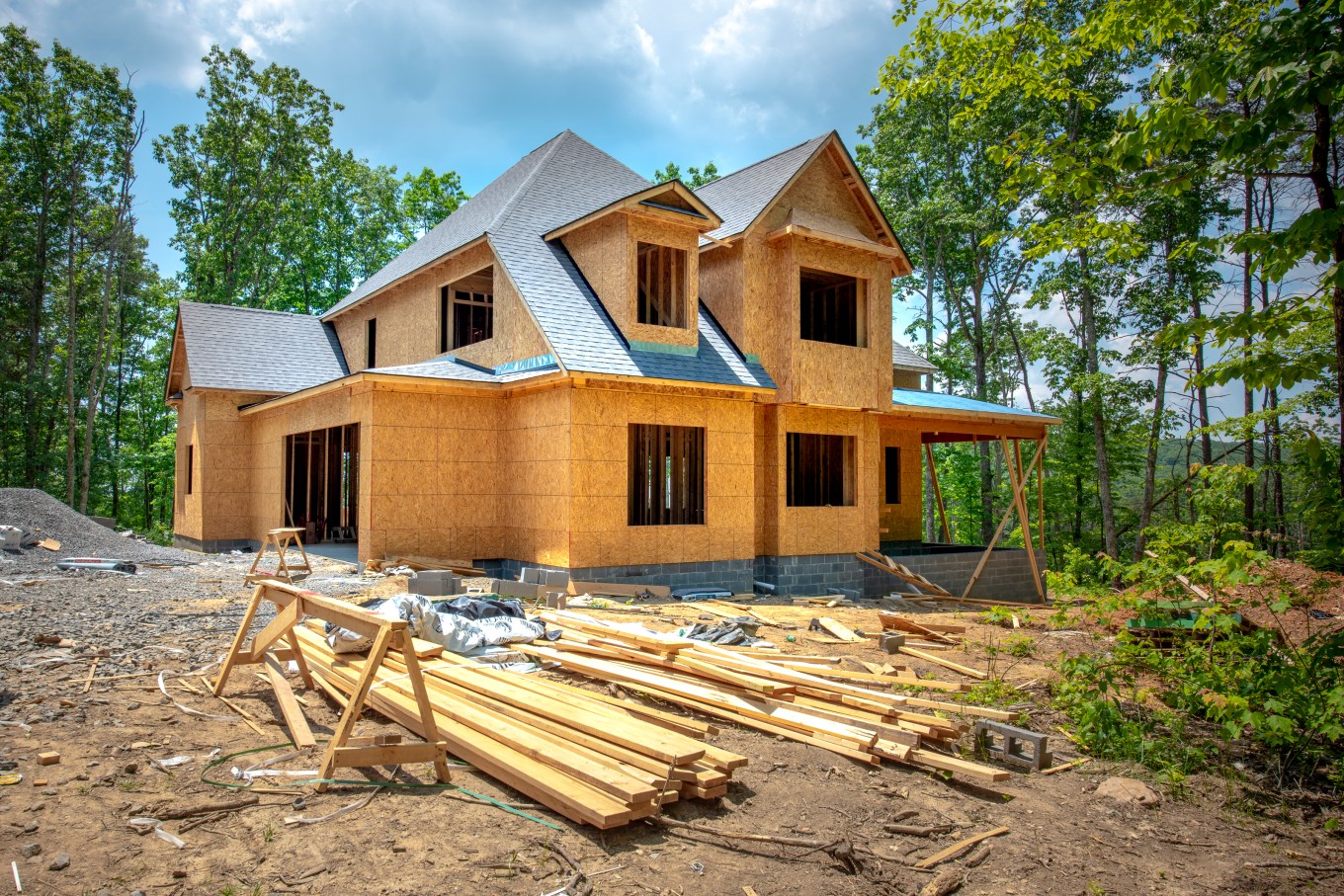 A new home being constructed around trees and with uneven terrain offers many considerations.