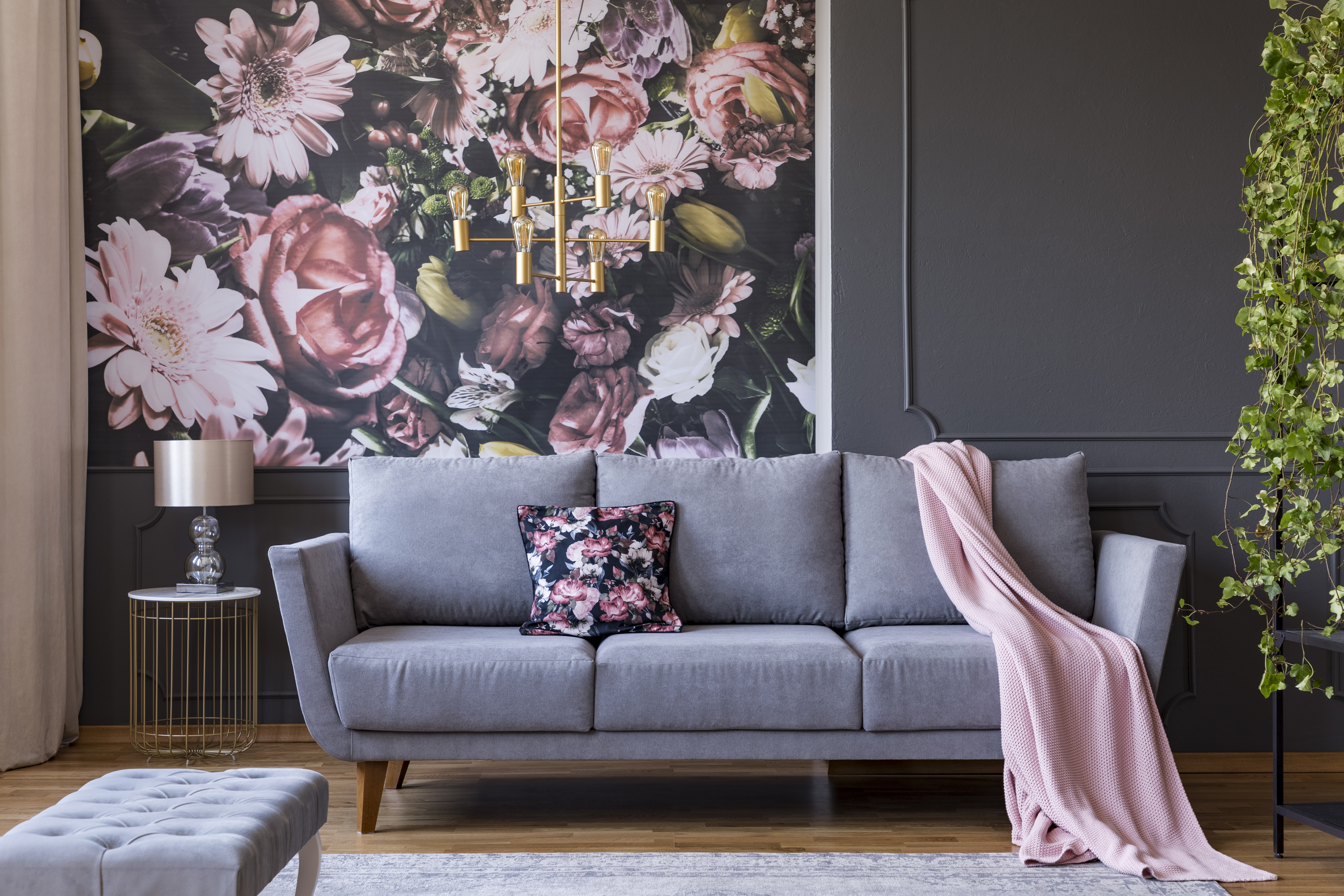 Living room with colorful wallpaper and trimmed walls filled with modern furniture.