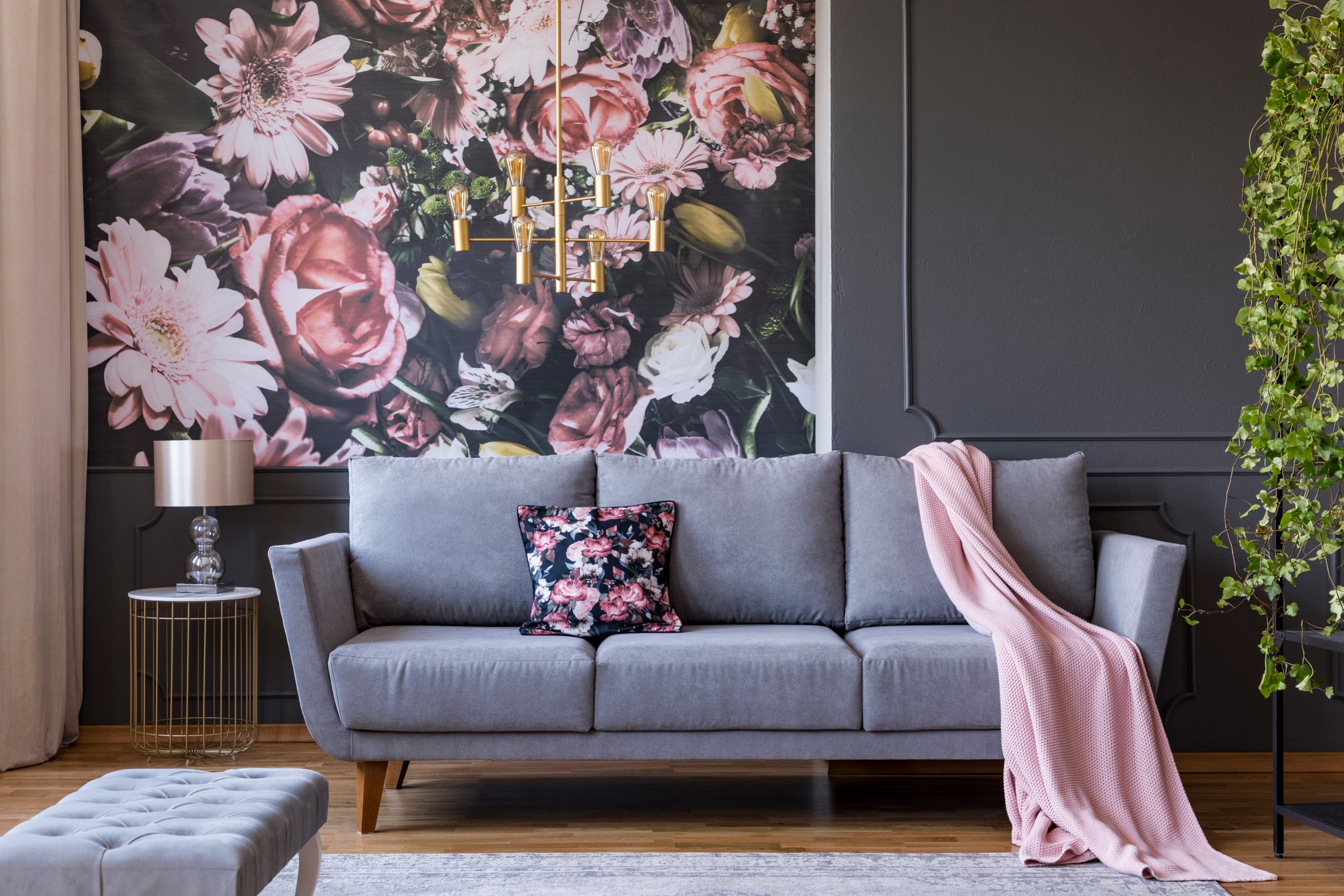 Living room with colorful wallpaper and trimmed walls filled with modern furniture.