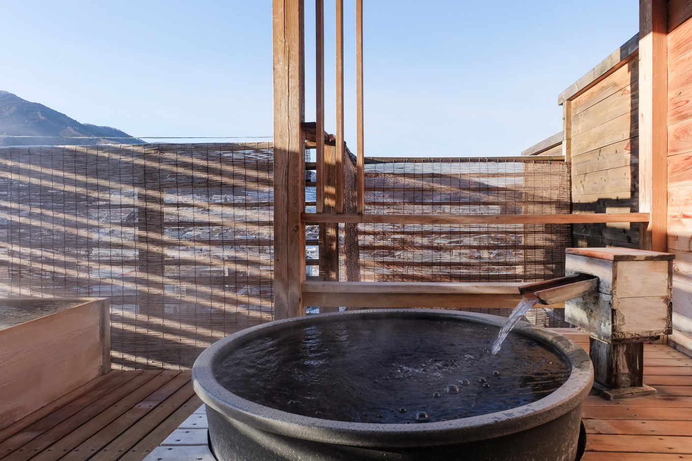An above-ground, open-air plunge pool on a patio.