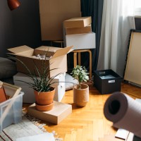 Shot of a living room corner filled with boxes with personal belongings from a buyer moving in.