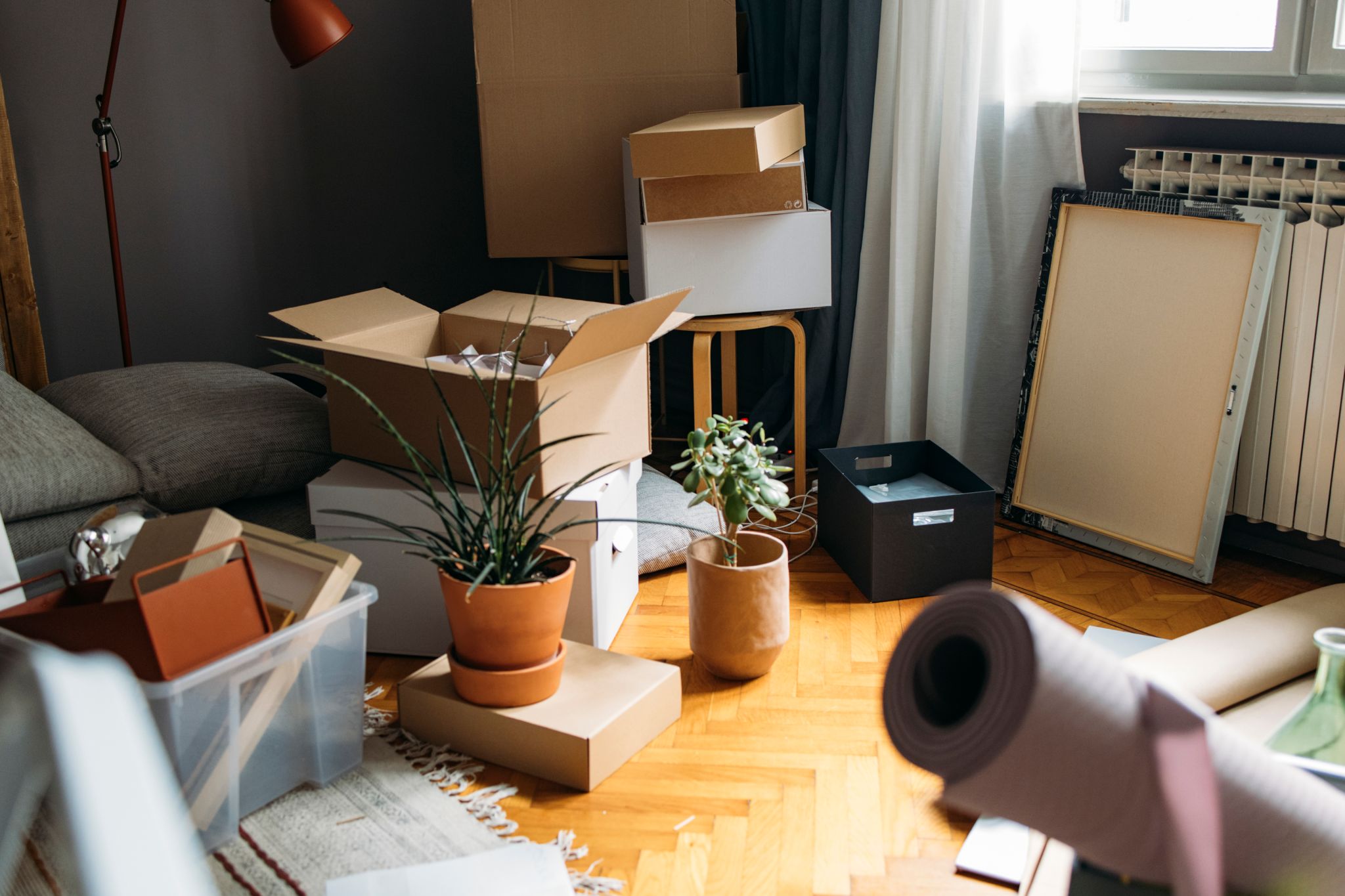 Shot of a living room corner filled with boxes with personal belongings from a buyer moving in.