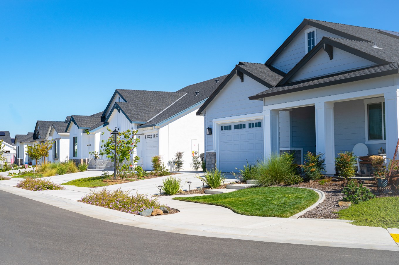 View of a row of single story suburban homes from the street.