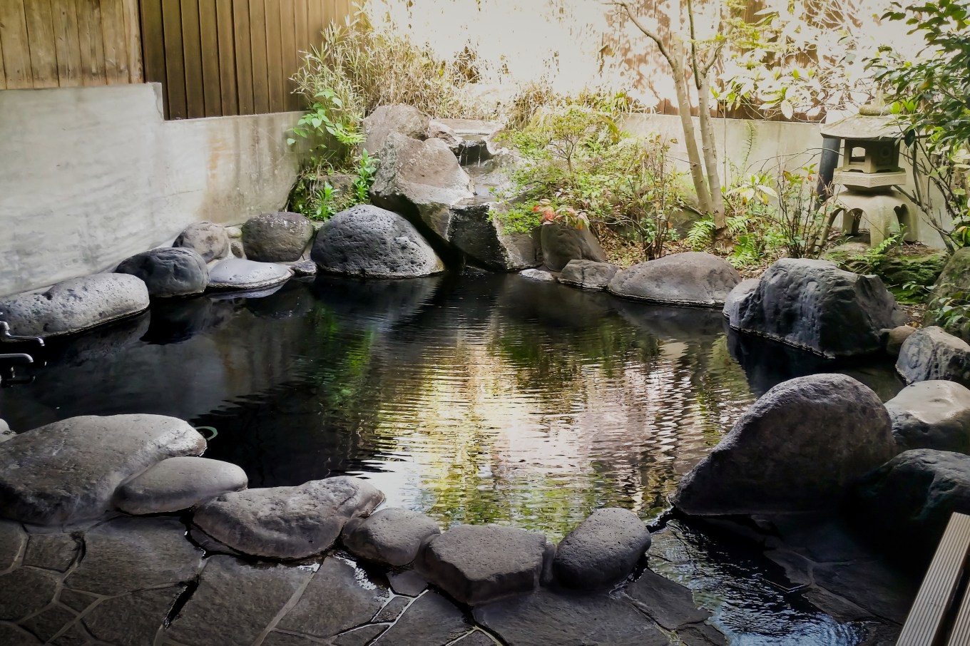 A natural plunge pool surrounded by stones in a circular shape.