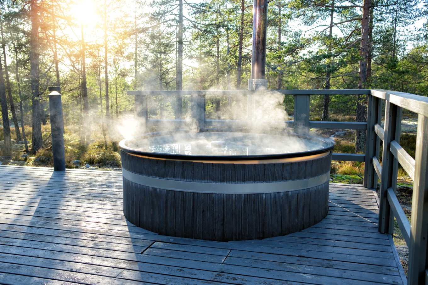 A modern, big barrel, temperature controlled plunge pool outside with steam.