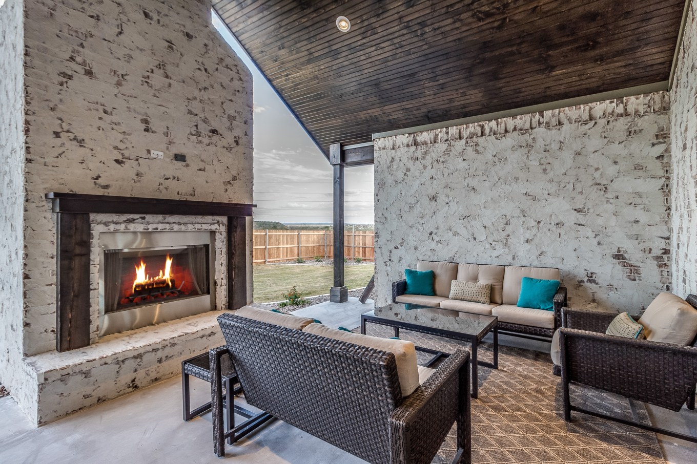 Large traditional outdoor fireplace and seating for several to enjoy the fireplace.