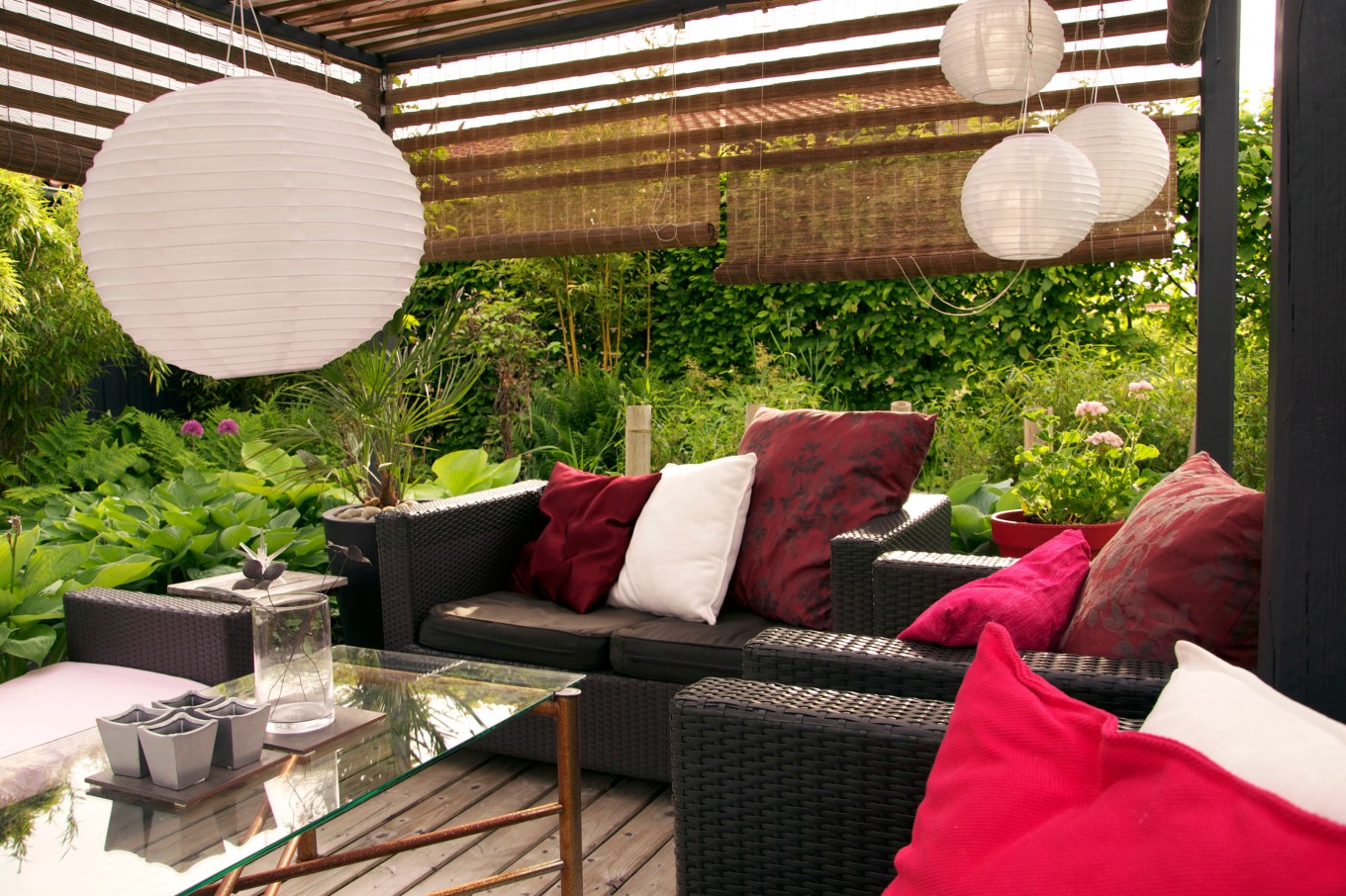 Reed shades giving privacy to a modern pergola in a backyard.