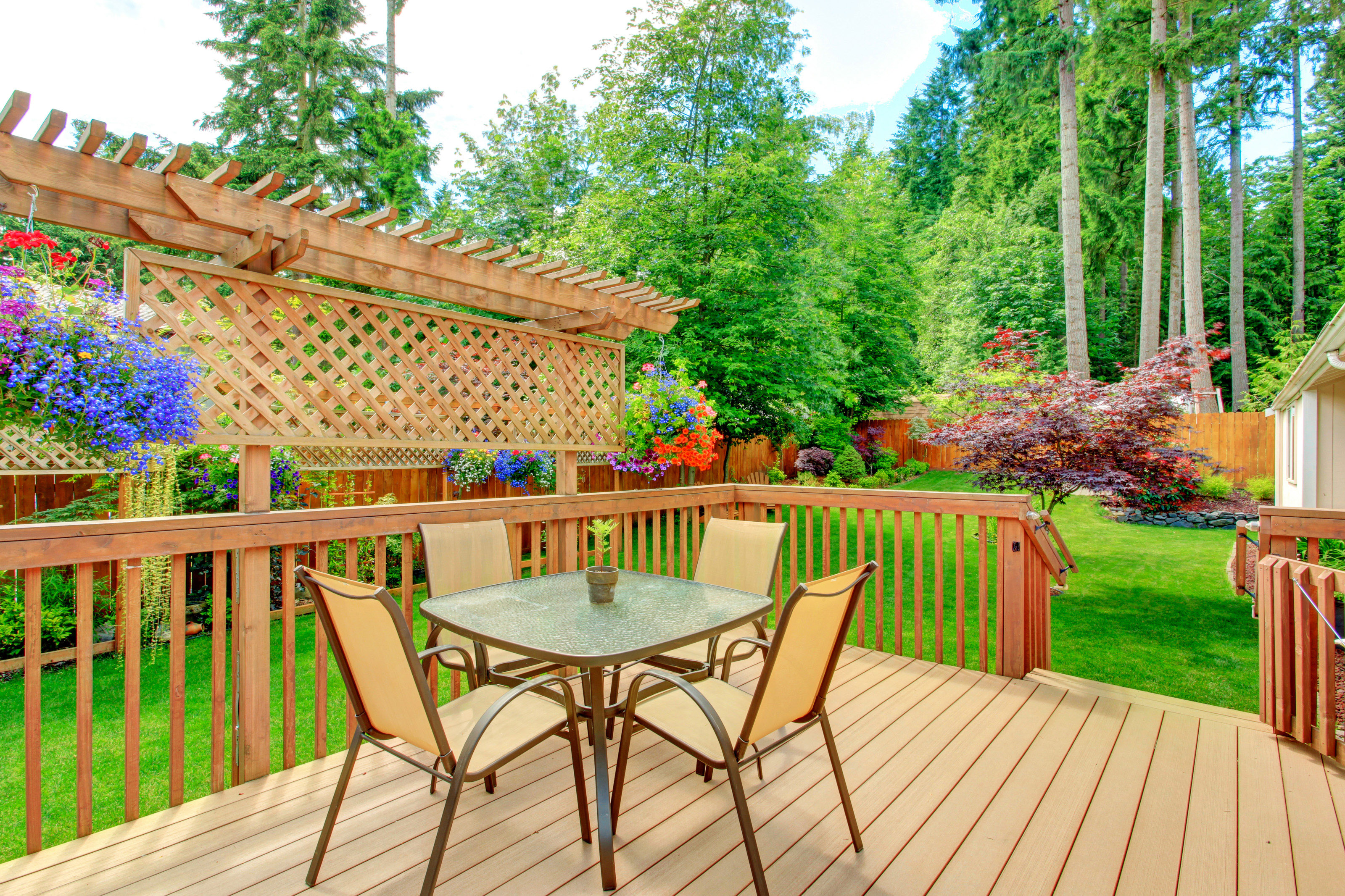 Cozy walkout deck with patio area. Deck with wooden trellis overlooking backyard garden