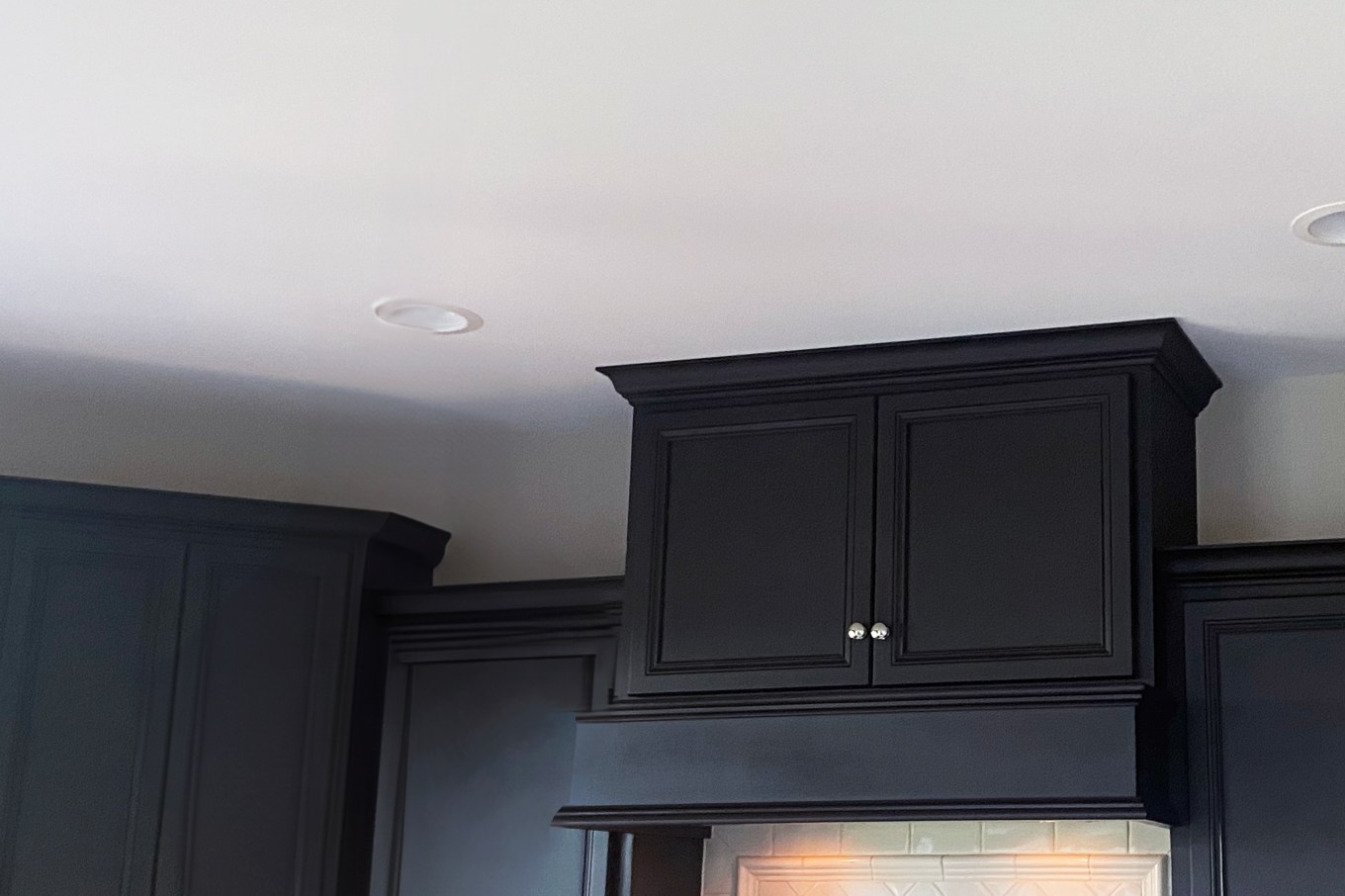 An example of crown molding on a dark cabinet.