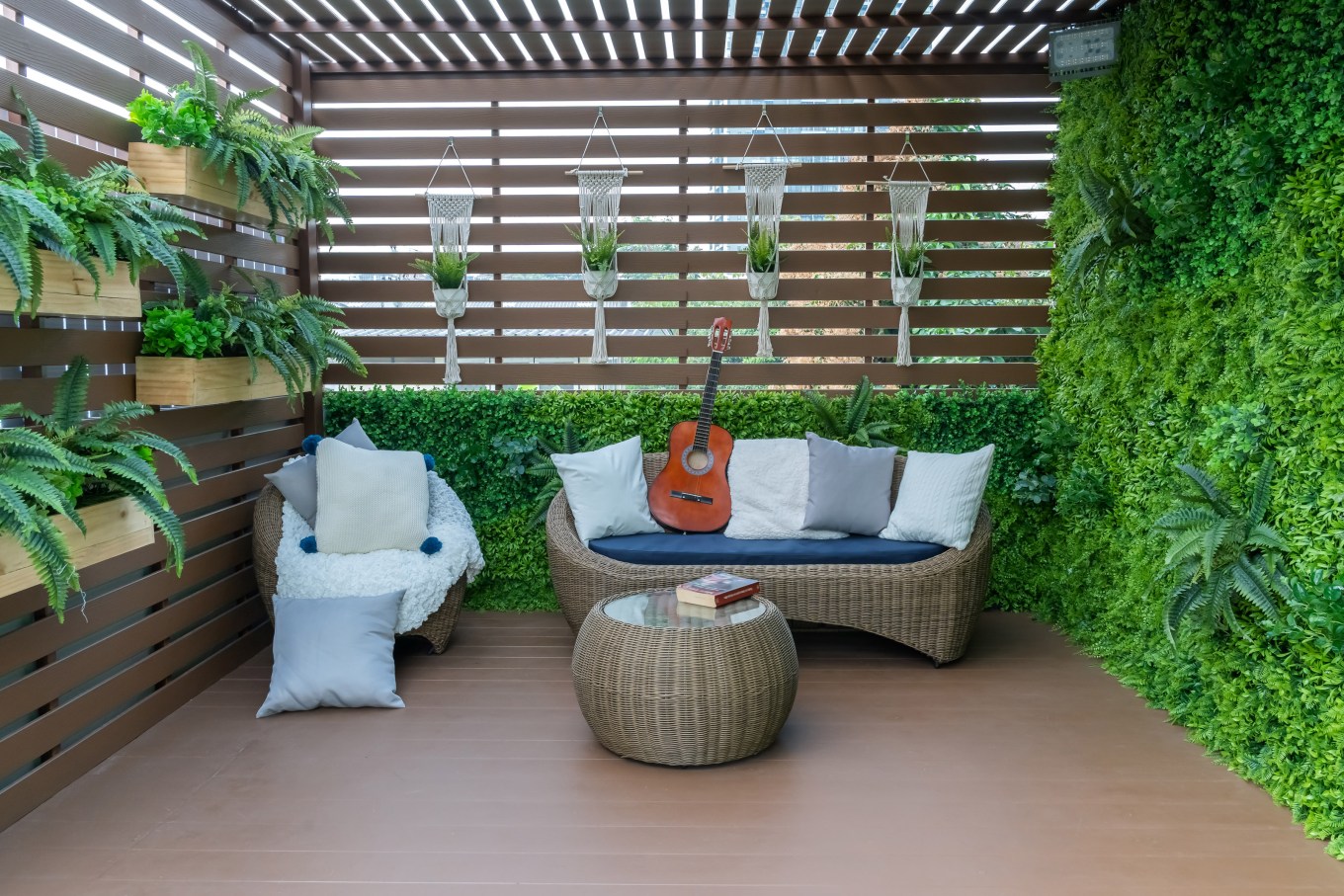 Seating in the garden on the balcony surrounded by plants, is a recreation place.