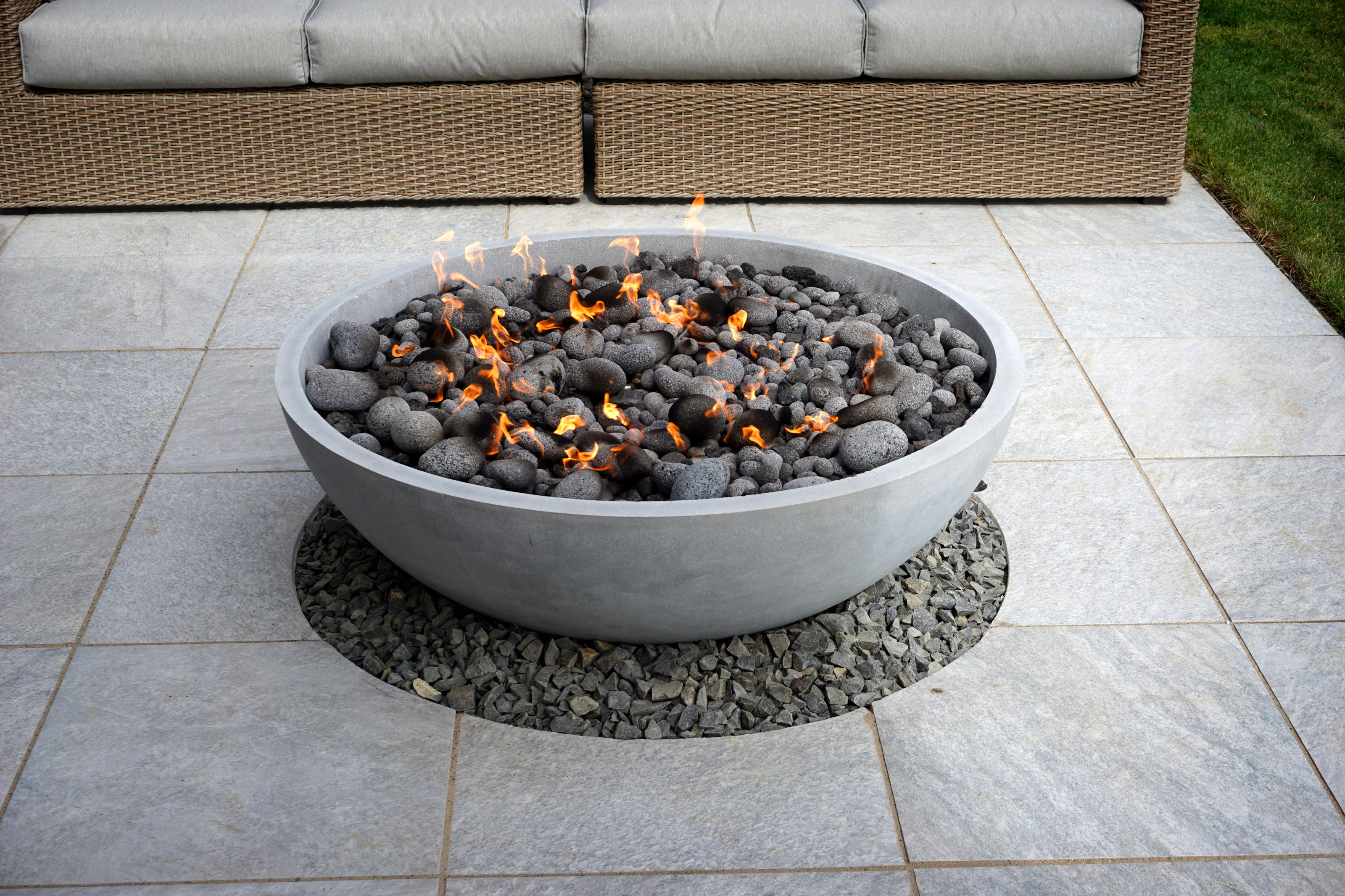 Front patio area with a lit fire pit. 
