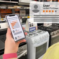 A picture showing a consumer checking online reviews for appliances on their phone.