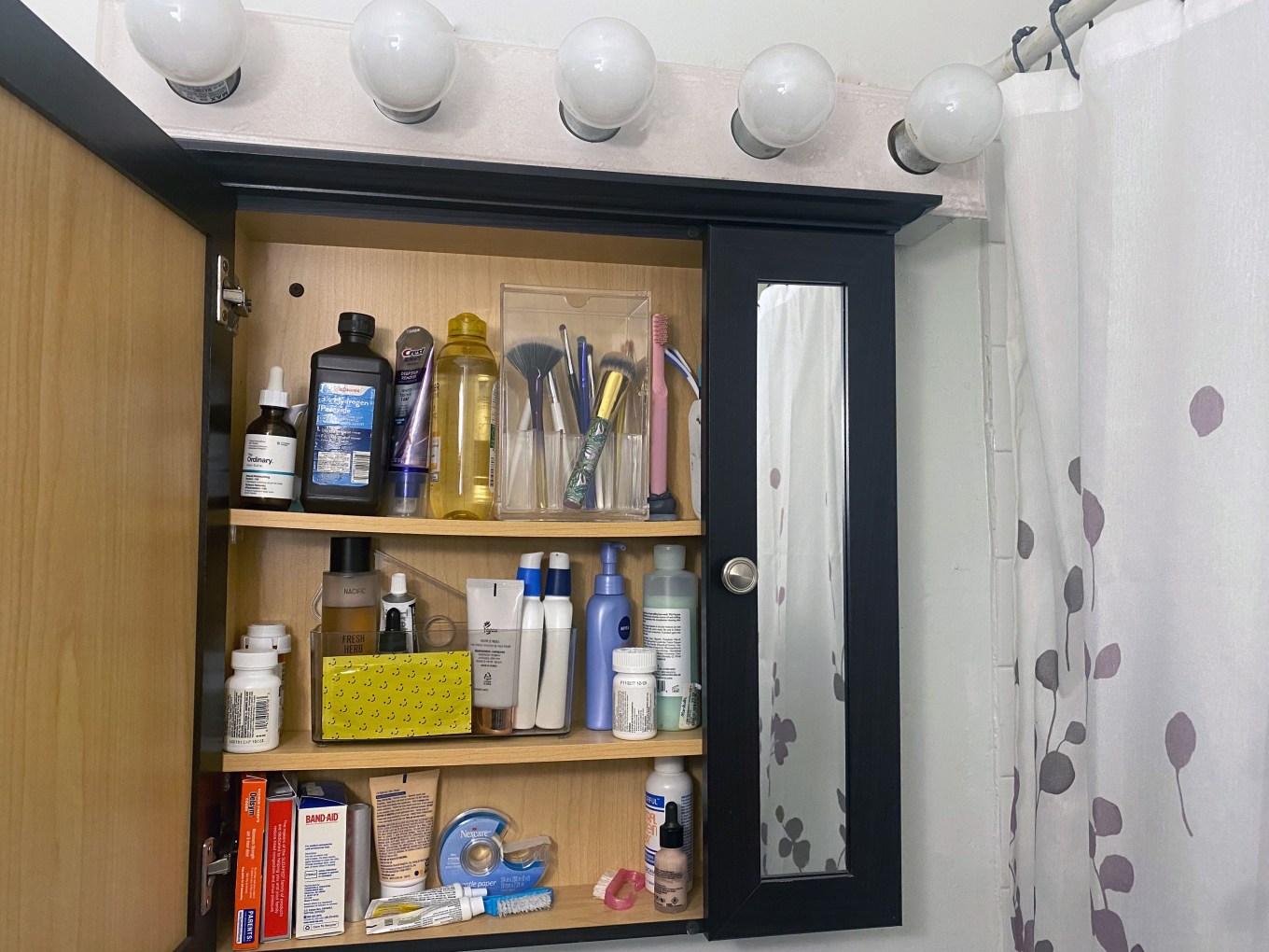 A bathroom cabinet full of expired products.