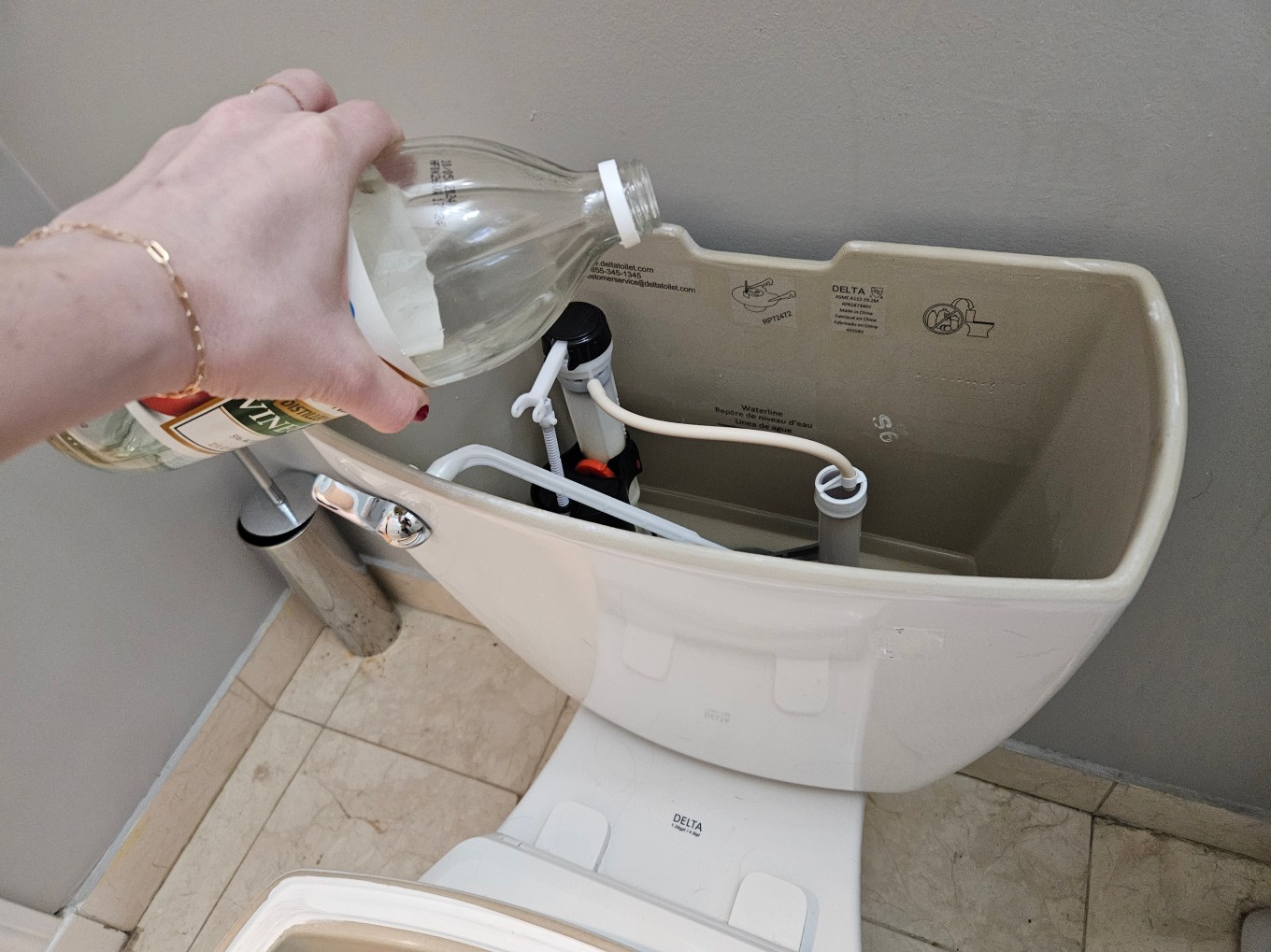 Using vinegar to clean the tank of a toilet.
