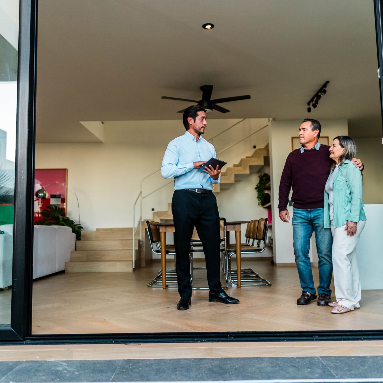 Real estate agent showing house to senior couple customers