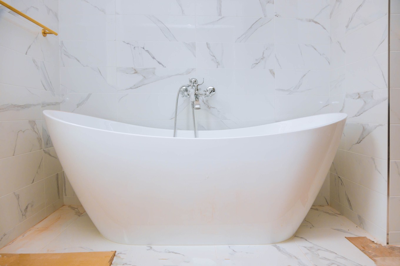 Classic bathroom interior with tiles and a freestanding bathtub.