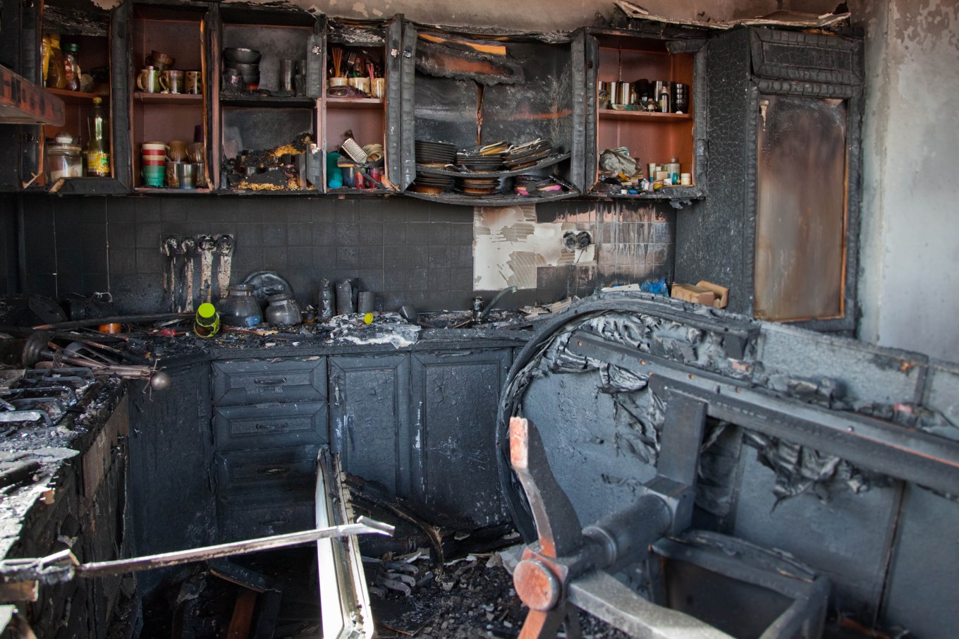 A burnt kitchen after a fire, highlighting the importance of fire safety.