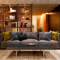 A well illuminated picture of a living room with a sofa and modern lighting.