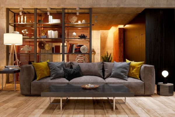A well illuminated picture of a living room with a sofa and modern lighting.