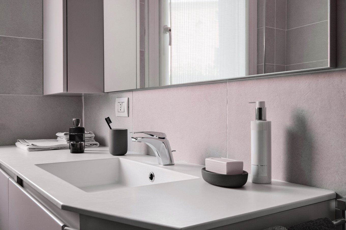 Interior shot of a modern bathroom in foreground the integrated washbasin with faucet.