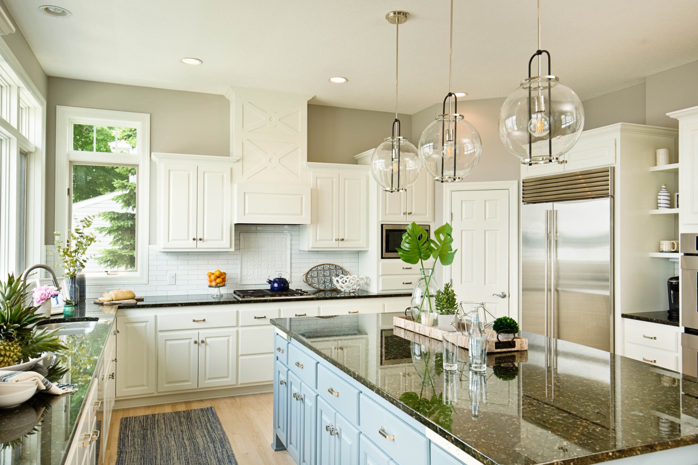 Modern kitchen with brushed nickel hardware and quartz countertops.