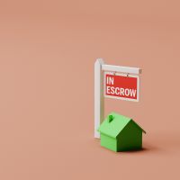 A graphic of a green house with an oversized sign reading "in escrow"