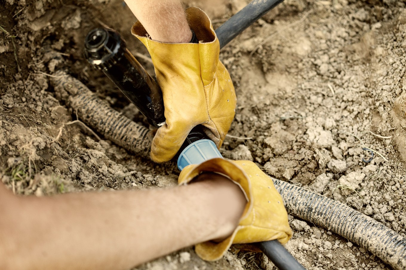 Closeup of someone installing a sprinkler system.