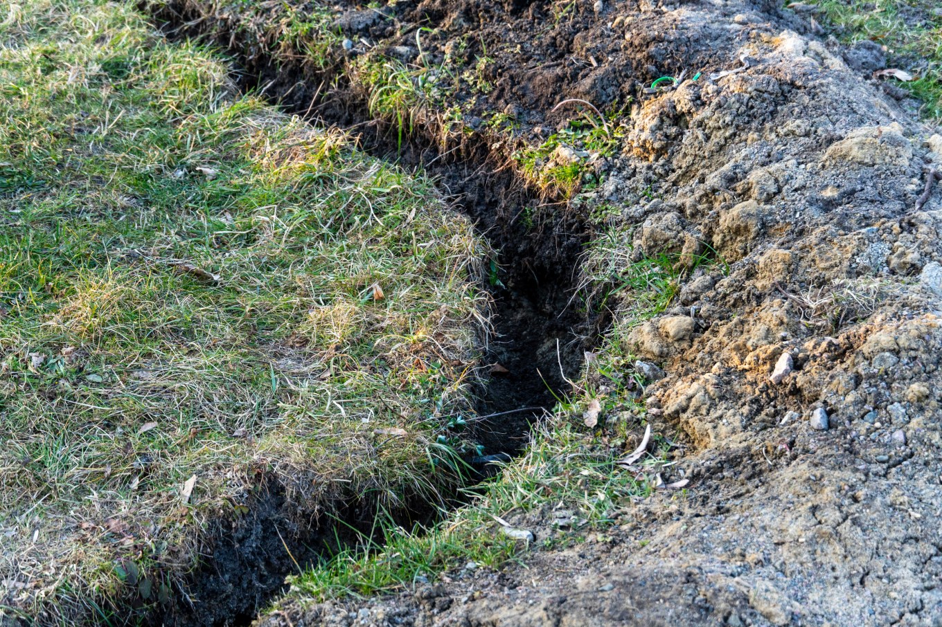 A trench cut into the earth which allows for a sprinkler system.
