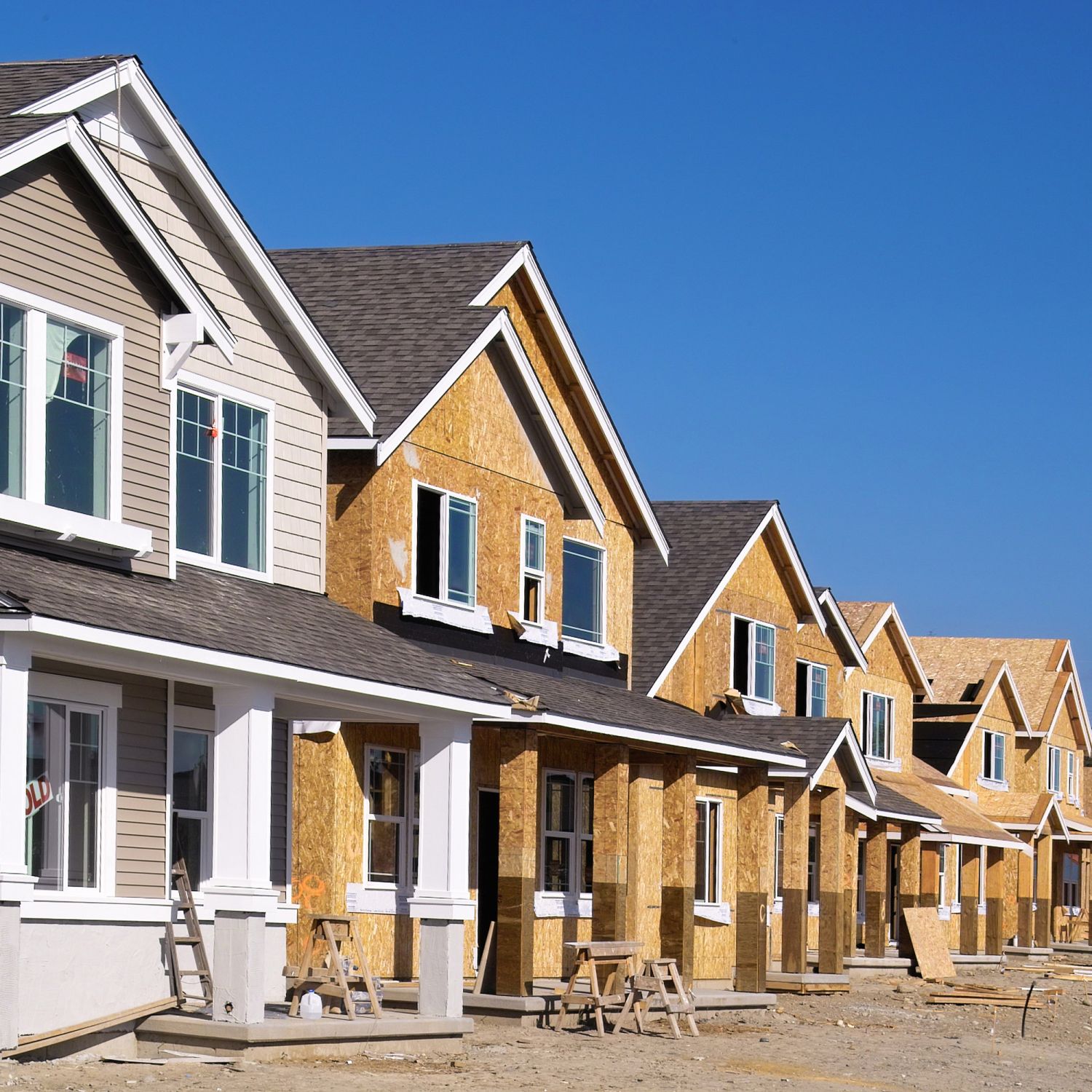 Perspective photo of a row of new construction homes.