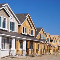 Perspective photo of a row of new construction homes.