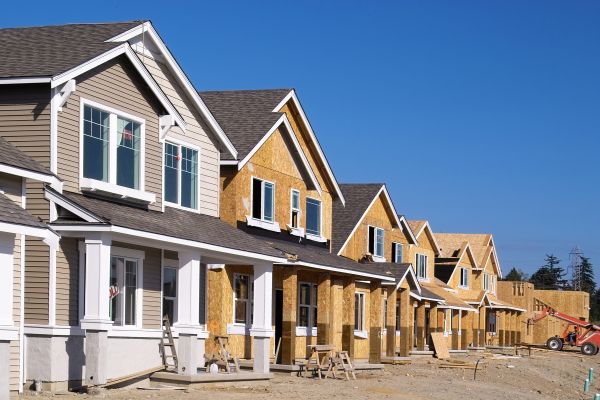 Perspective photo of a row of new construction homes.