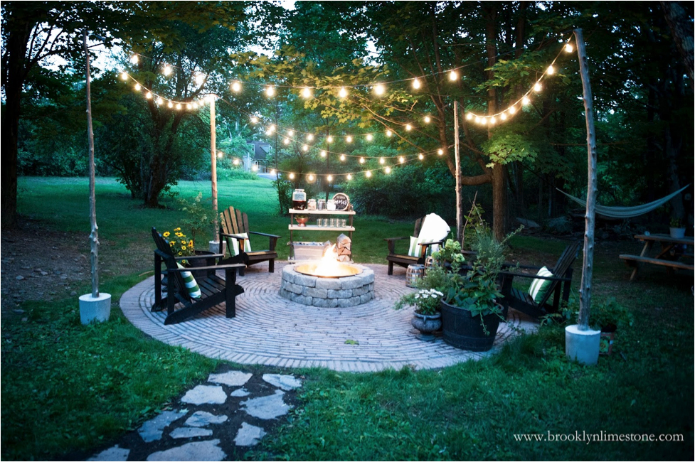 An outdoor patio with a firepit at dusk
