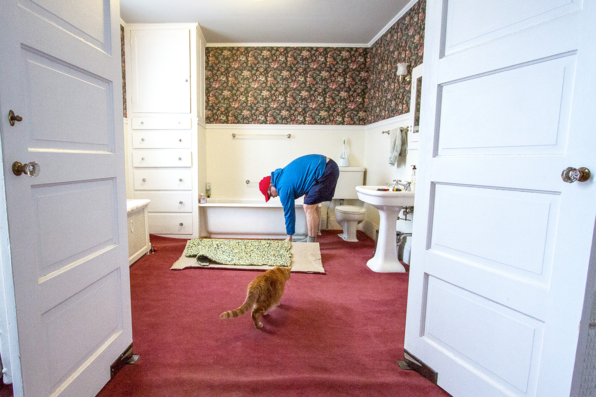 Man removing carpet from a home bathroom