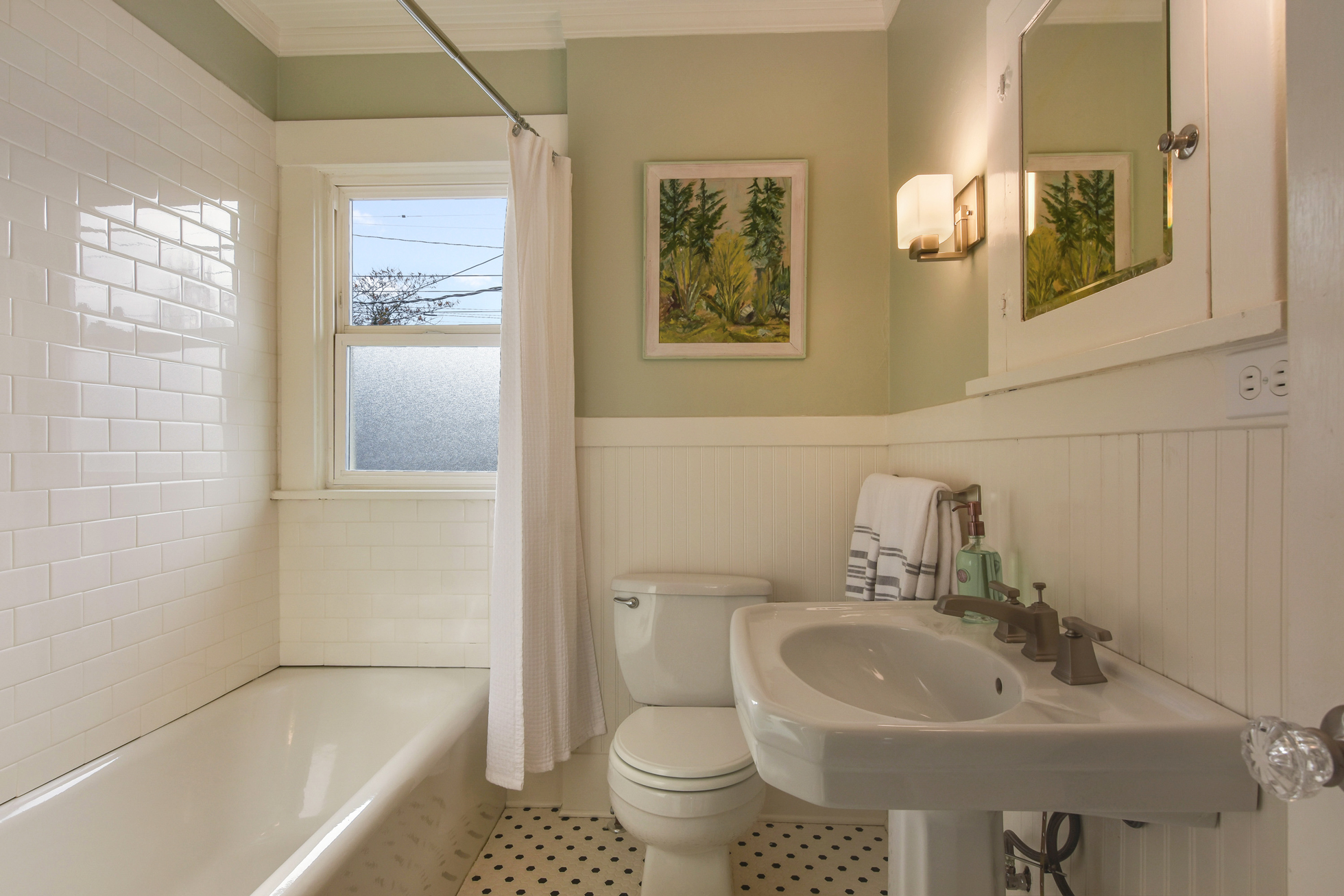 A vintage bathroom with a window in the shower