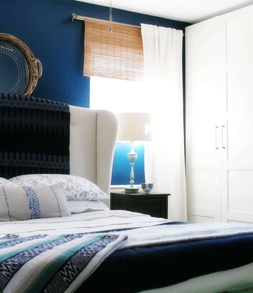 Blue bedroom with white accents and white curtain