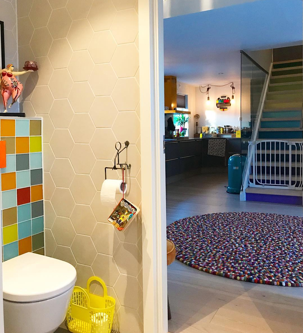 Bathroom with colorful tile showing glimpse of gum ball rug