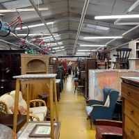 Overwhelming view of furniture at a thrift store.