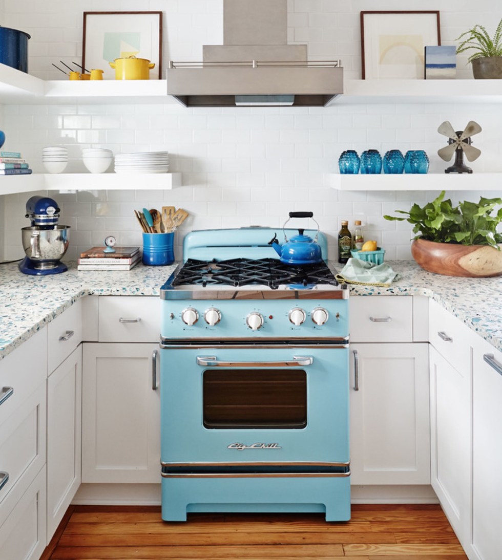 Baby blue stove with stainless steel hood in white kitchen